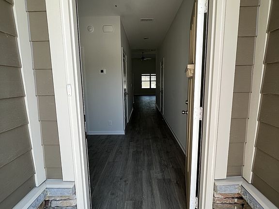 starting at the front door there is laminate flooring in the foyer, great room, kitchen, dining roo