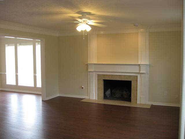 Large Den/Living Room with fireplace trimmed with molding accents & mantel