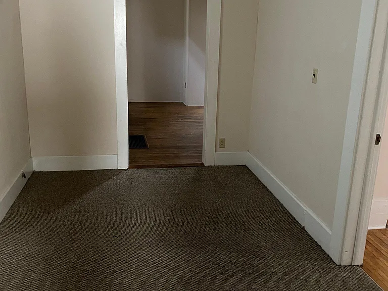 Bonus room between Living room and dining room. Door on right is main level bedroom.