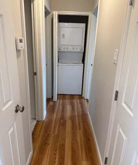 Stackable washer & dryer in hallway. -