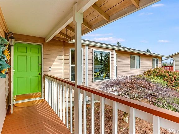 Inviting entryway with lovely mature landscaping in front yard