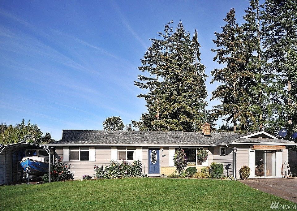 Front of the house with covered carport and drive way