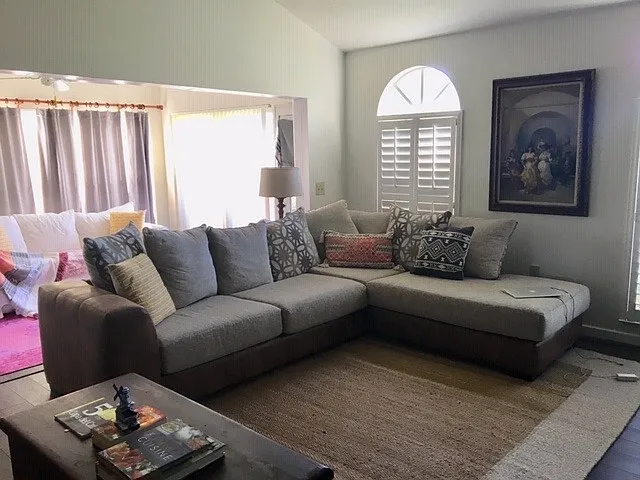 Huge Living room and a sun room with a large sectional and TV.