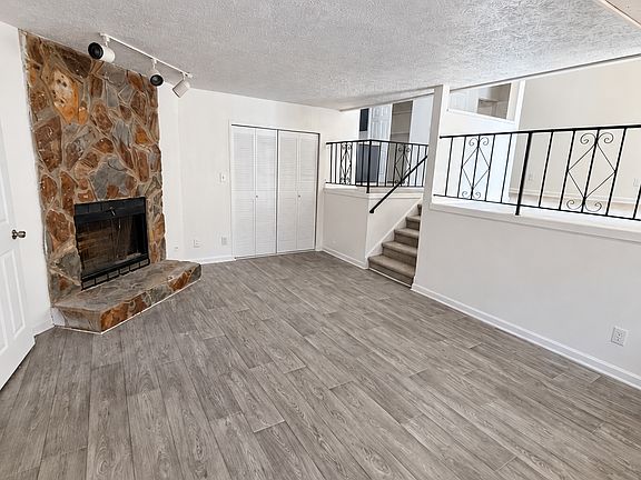 Flat - living room with stone fireplace