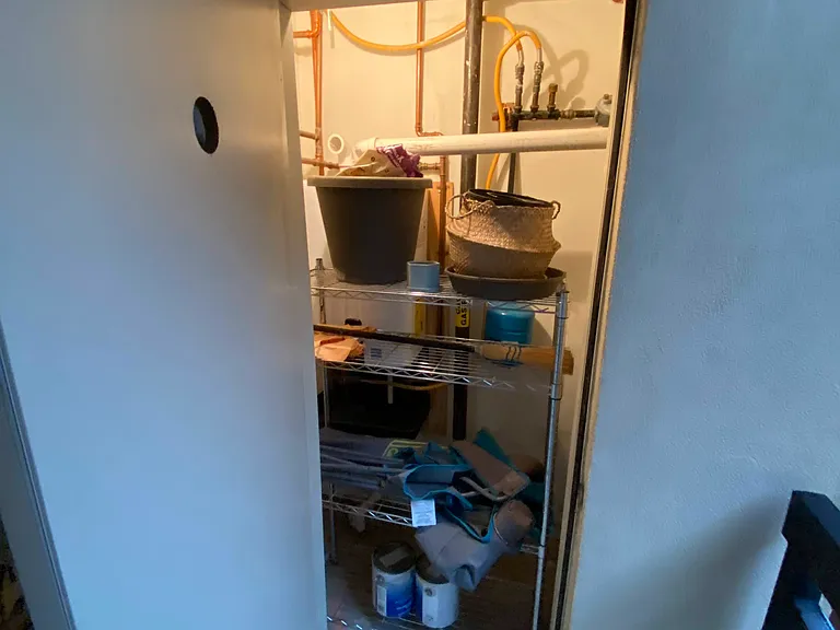 Outdoor storage area perfect for gardening supplies.