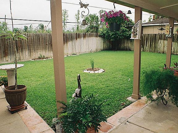 Rear yard from the covered porch showing a wide area for kids