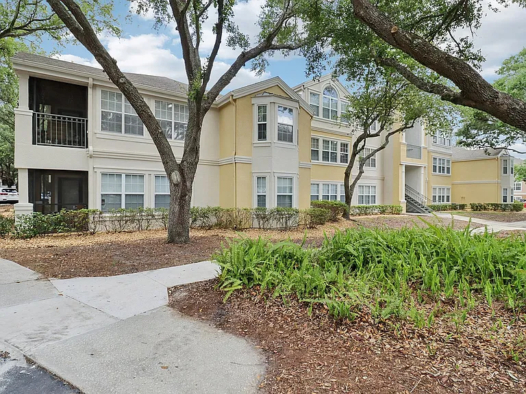 Peaceful apartment living with beautiful landscaping and shaded walkways