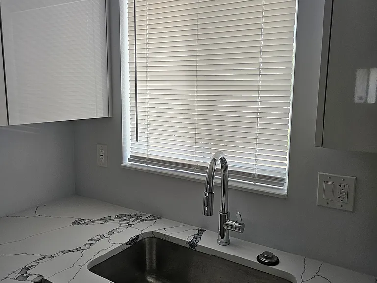 Large kitchen sink with kitchen window.