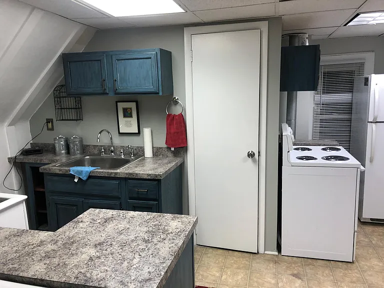 Kitchen area: new cabinets, countertop and facuet. Stove & Frig provided for YOUR convenience. Freshly painted