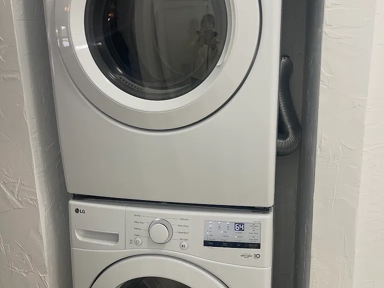 This modern stacked washer and dryer unit was purchased in January and is in excellent condition.