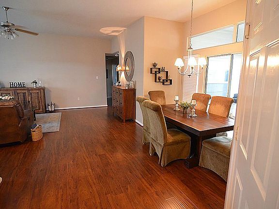 Entry. Laminate wood flooring, dining area with windows.
