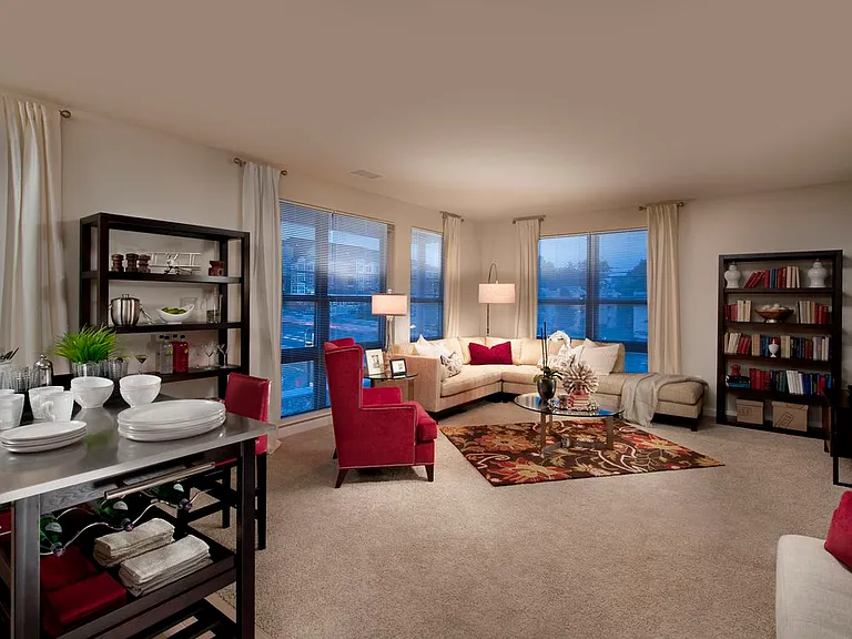 Open concept kitchen with movable island and living area with carpet