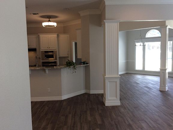 DR on the right with open kitchen on left. Picture taken looking from entry hallway to master suite.