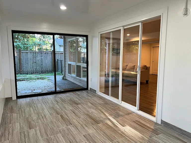 Enclosed sunroom offers versatile bonus space.