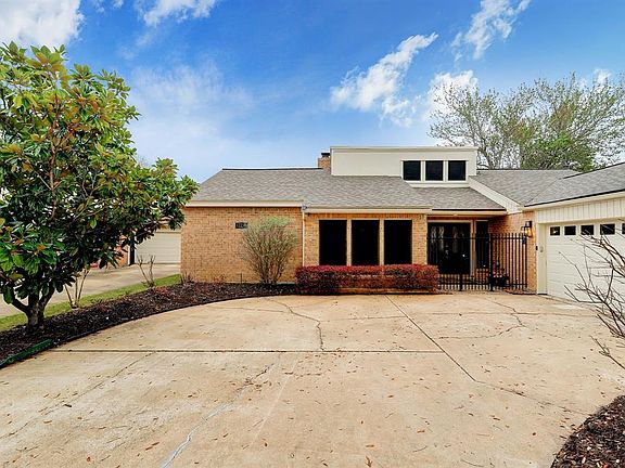 Expansive driveway leading to two car attached garage. Beautiful Magnolia welcomes you home. Gated front entry.