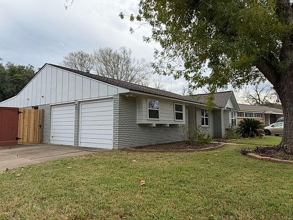 Exterior of home, including parking pad