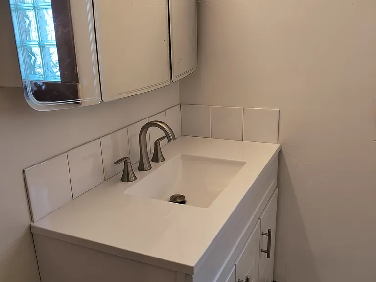 Full bath off kitchen. First level. New shower and vanity