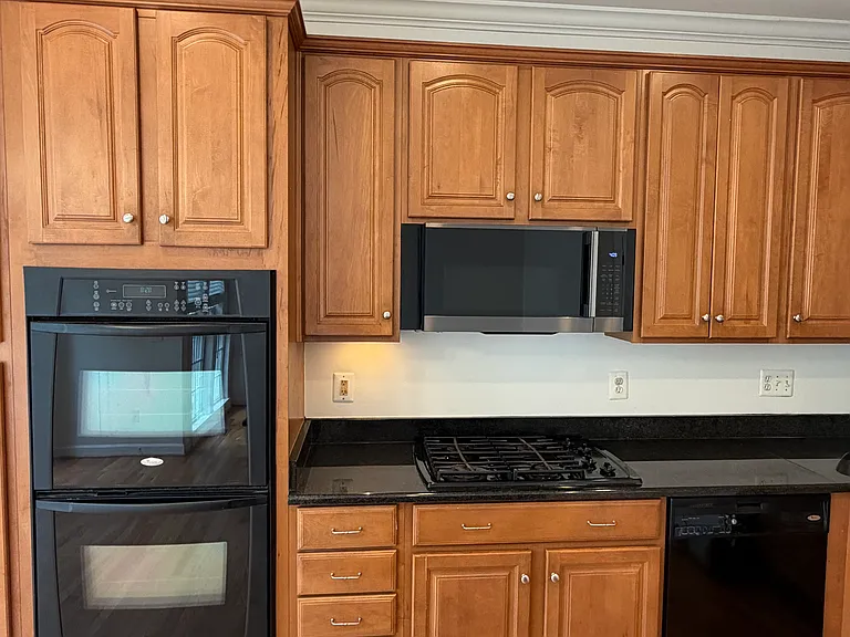 Looking over the granite countertops toward the cooktop