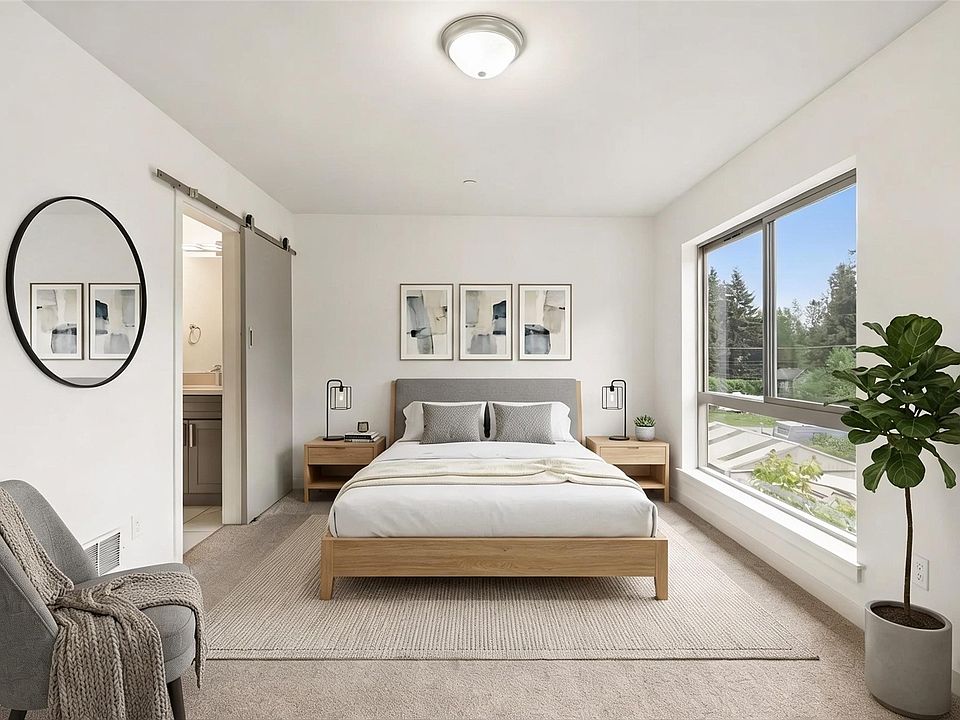 Secondary bedroom on the same floor with natural light, neutral finishes, and private ensuite bathroom.