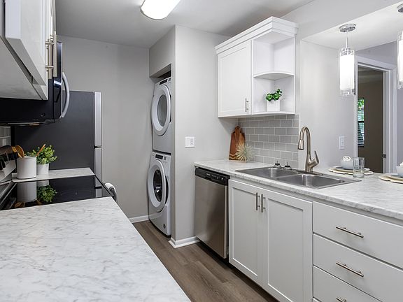 Premiere kitchens dressed in marble-style countertops, a chic tile backsplash, and a breakfast bar to cherish.