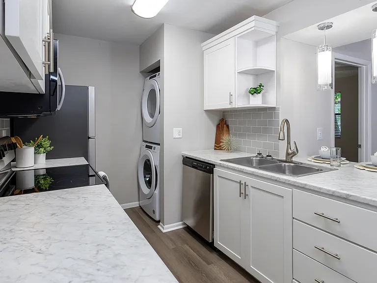 Premiere kitchens dressed in marble-style countertops, a chic tile backsplash, and a breakfast bar to cherish.
