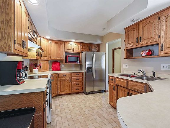 Kitchen offers abundance of cabinets and eat in breakfast bar