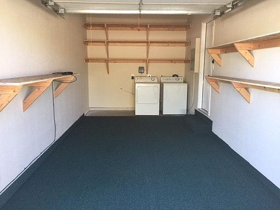 carpet floor garage storage shelves washer and dryer include