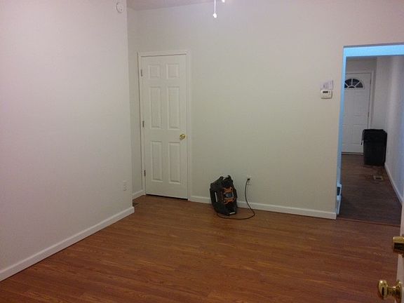 Living room w/ door to basement w/ extra toilet