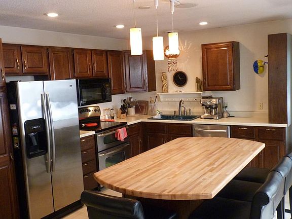 Large kitchen island with seats / stools for 8, connected to TV sunroom