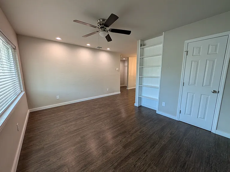 Living room with built-in bookshelf and closet