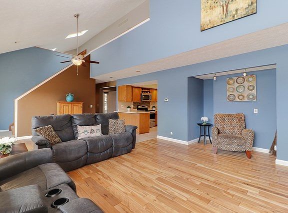 Beautiful family room with vaulted ceiling & rich hardwood flooring!