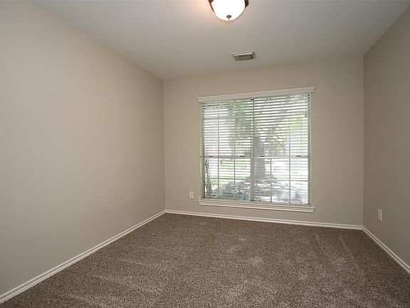 A large picture window allows views of the front yard space from this formal dining room! It could easily be converted to a home office, study, or even an exercise room!