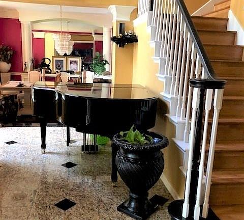 Travertine tile, crown molding and pillars.