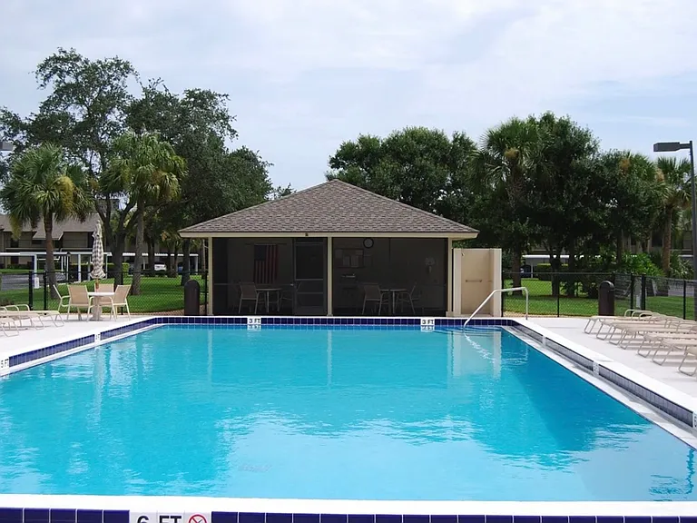 Recreation B pool has bathrooms, water fountain, and screened in porch with tables and chairs.
