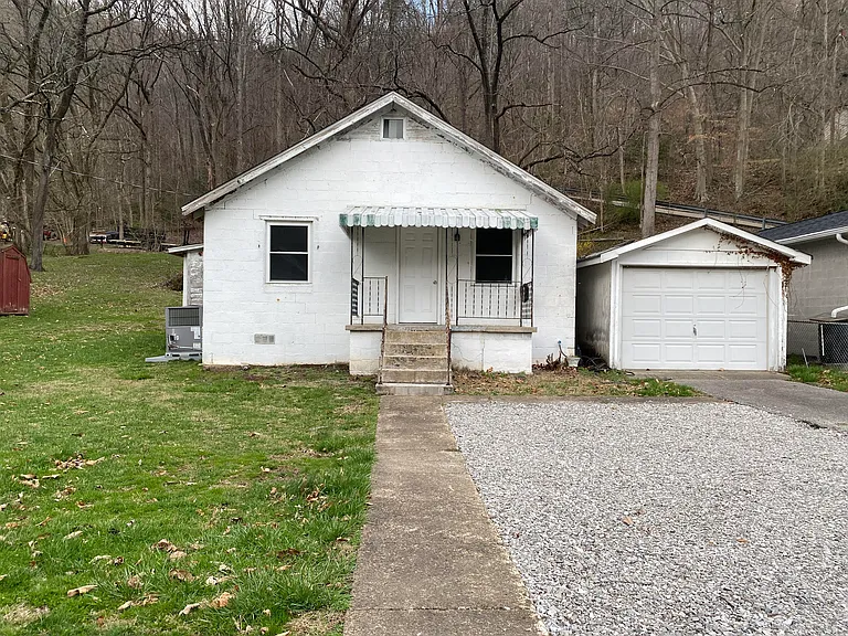 Front of house with garage and additional parking