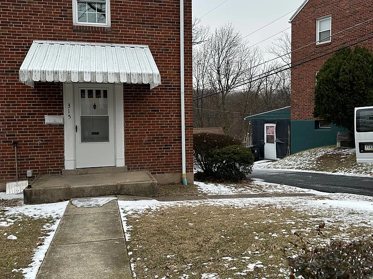 Front, driveway to the side