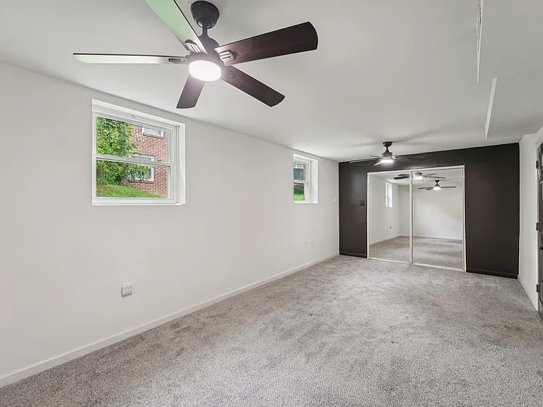 A peaceful lower level haven where clean lines, soft textures, and gentle light come together to create comfort, privacy, and quiet storybook charm.