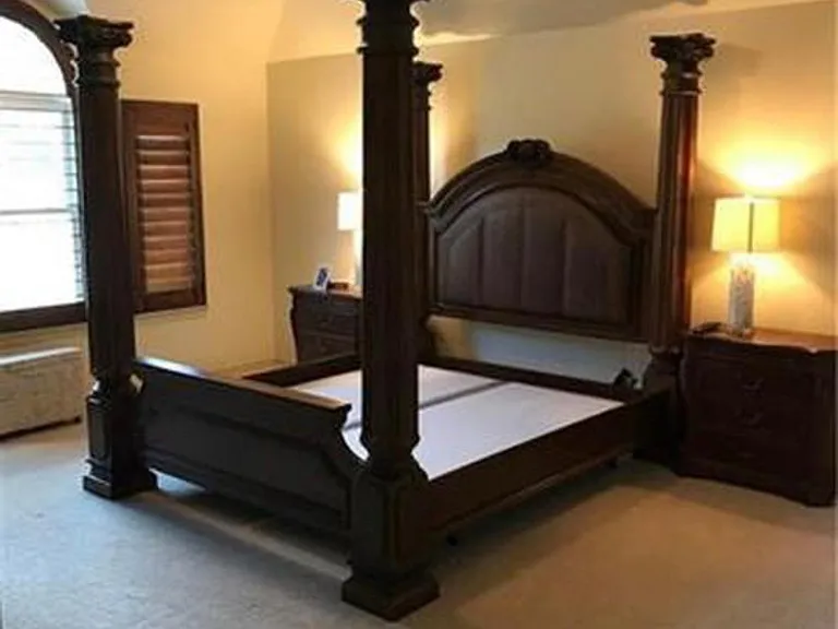 Large master bedroom with shutters and his and her closets.