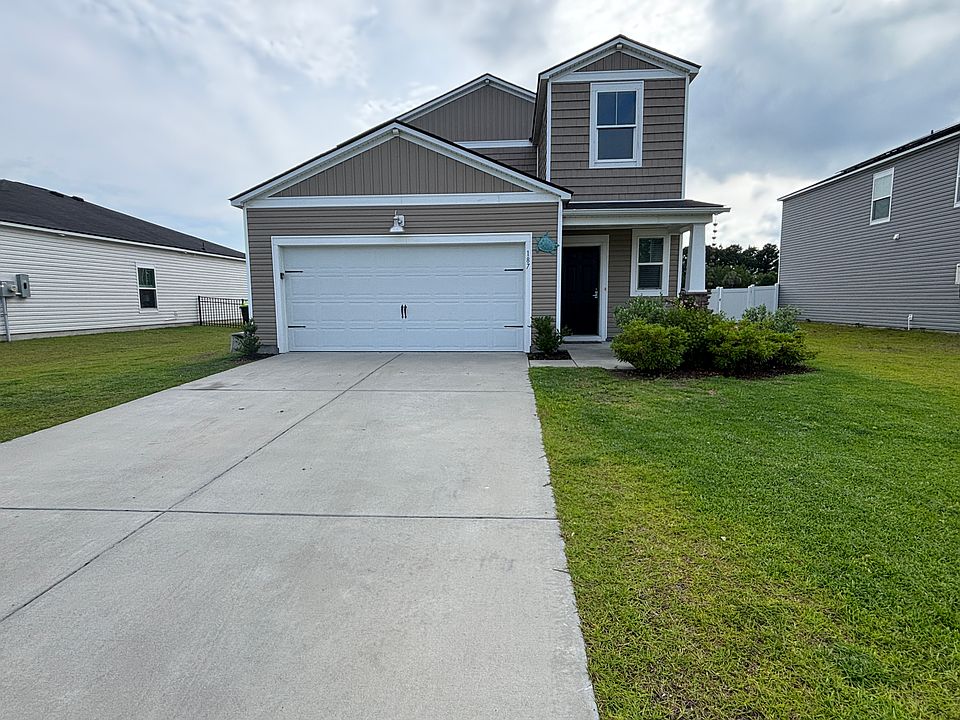 Beautiful home with long driveway and two car garage.