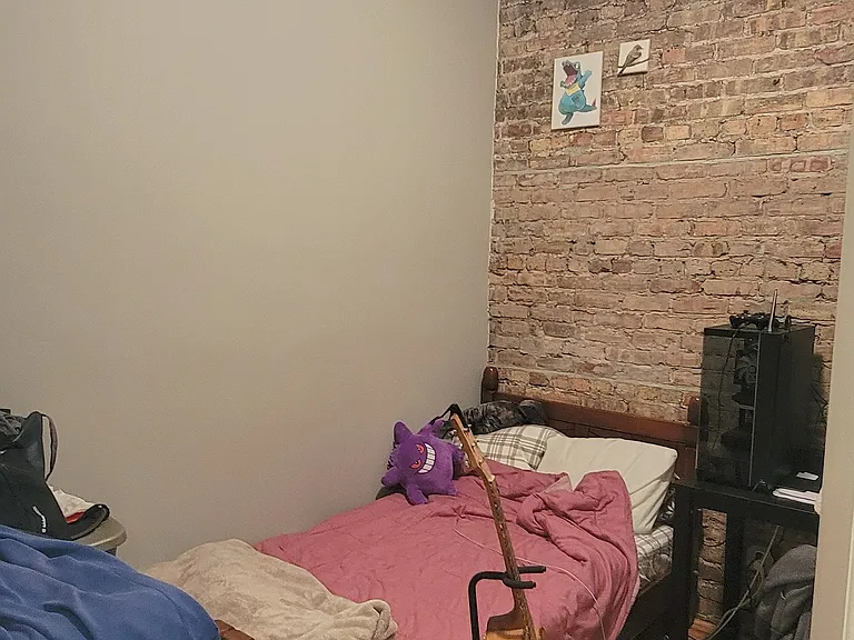 Bedroom with 10' ceiling, exposed Chicago brick wall, restored oak floors and high end light fixture