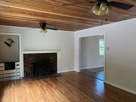 Living room with wood burning fireplace.