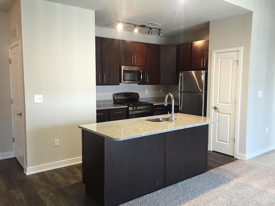 Modern kitchens with granite counter tops, island, full stainless steel appliance package and built in track lighting