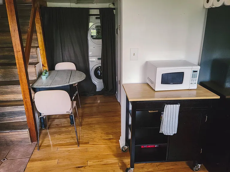 In-unit washer and dryer, small kitchen table. Bathroom is the door behind microwave.