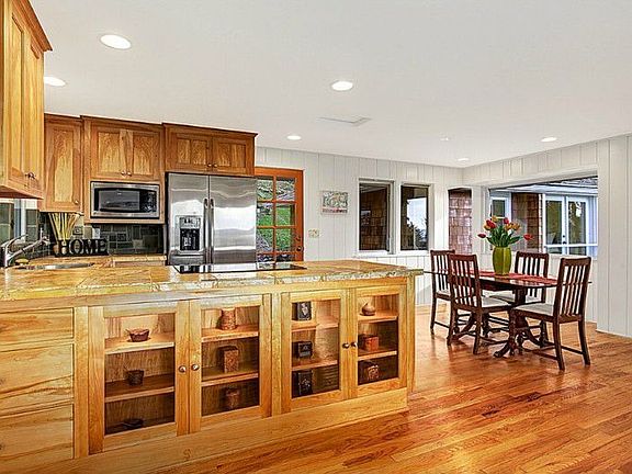 Built-in china cabinet with interior lights. The open floor plan boasts a dining room next to the ki