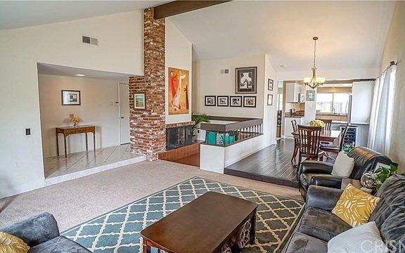 Living room with vaulted ceilings, fireplace & for