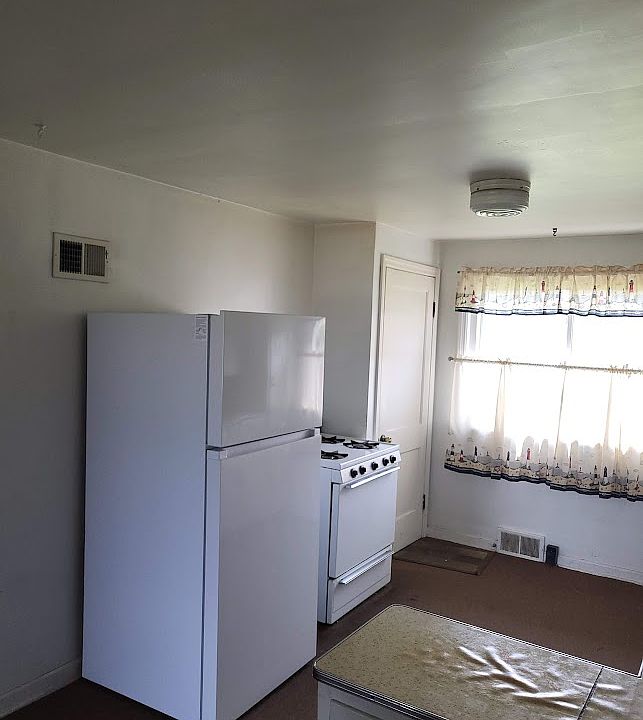 Kitchen, Gas Stove & Refrigerator
Door at rear of picture is door to basement with laundery pair. Back door to back yard.