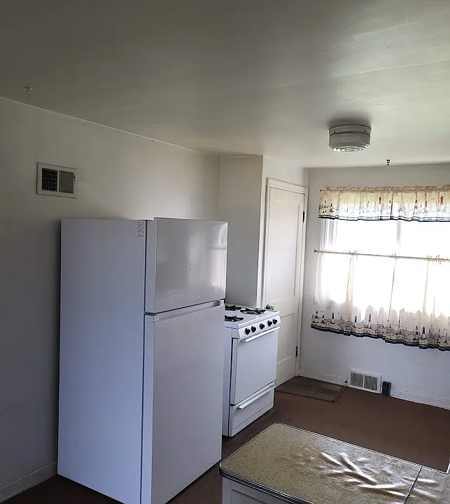 Kitchen, Gas Stove & Refrigerator
Door at rear of picture is door to basement with laundery pair. Back door to back yard.