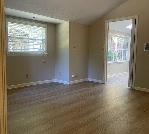 Bedroom; as viewed from the bathroom, facing backyard window, and doorway to living room
