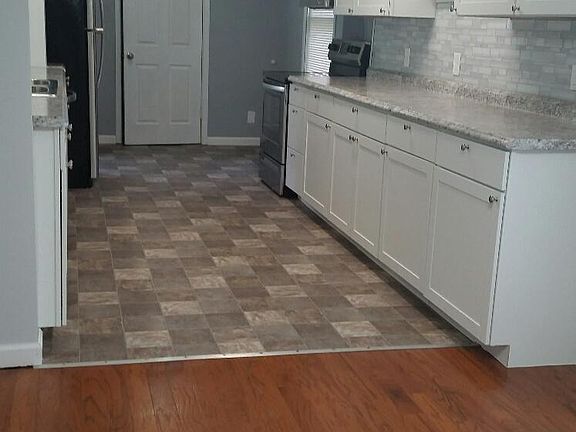 Dining area with hardwood flooring, washer/dryer connections off kitchen