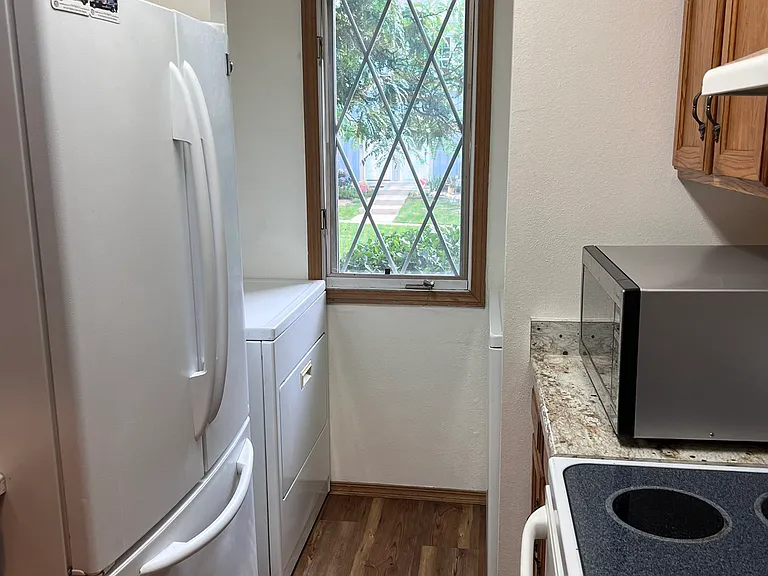Just off the kitchen are the washer and dryer, also included.